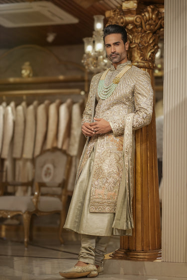 Green heavy embrorided sherwani set with matching churidar